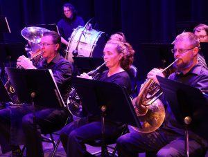 The band practices before its concert in May. On the right in the front row is Scott Farquhar, who will be soloist for a song at the upcoming concert.
