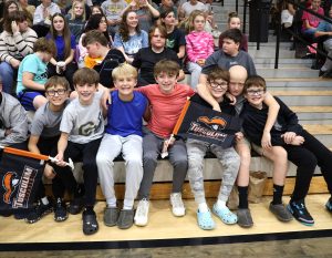 Fellow students gather around two of the prize winners at the game.