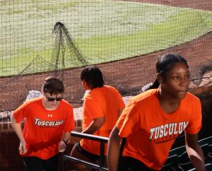 Tusculum women’s basketball players descend and climb steps.
