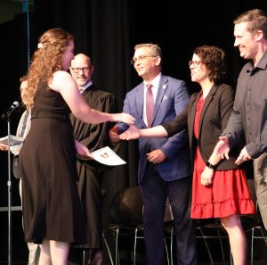 A new citizen shakes is greeted by, left to right, Judge Clifton Corker, Dr. Scott Hummel and Abigail Weaver and Jordan Weaver