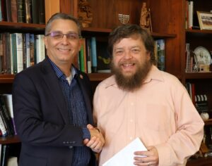 Steve Schultz, right, receives his check from Dr. Scott Hummel.