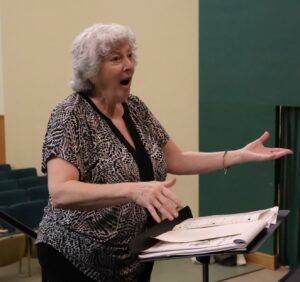 Kathy May directs the chorus.