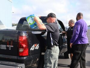 Shane Matthews, chief of campus safety at Tusculum University, loads bottled water into the bed of a truck.