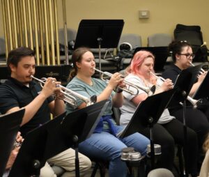 The trumpet section practices for the upcoming concert.