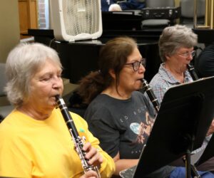 Members in the clarinet section play during practice.