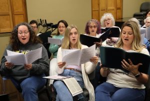 Chorus members practice for the upcoming concert.