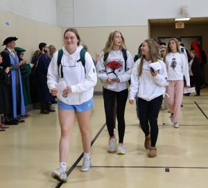 Students arrive for the Opening Convocation to applause from faculty and staff members.