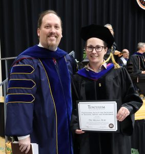 Dr. David Cook, left, presented the Outstanding Faculty for Excellence in Teaching, Service and Scholarship award to Dr. Melissa Burt.