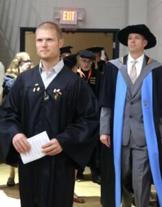 Dr. Dennis Ashford, associate professor of chemistry, left, and Dr. Travis Williams, professor of religion, enter Pioneer Arena.