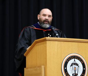 Dr. Peter Noll, former faculty chair, delivers a charge to his fellow professors.