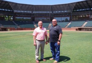 Jeff Idell, left, and his brother, Mike, stand on the infield at Eastman Credit Union Field at Pioneer Park.