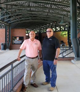 Jeff Idell, left, and his brother, Mike, stand on the concourse at Pioneer Park.