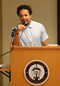 Student Aidan Dark shares a message with the audience.