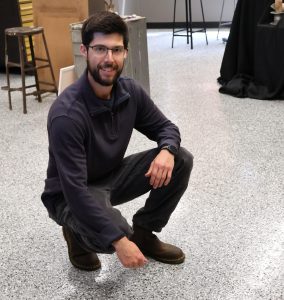 Benjamin Conley shows the new flooring in the 2-D studio art laboratory.