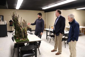 Benjamin Conley, left, shows Dr. David Cook, middle, and Clem Allison some of the features of the three-dimensional sculpture laboratory.