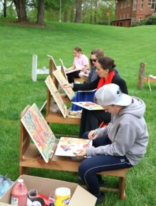 Participants work on their painting of the Old Oak Tree at the 2024 Old Oak Festival.