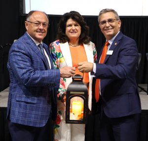 Dr. Scott Hummel, right, presents a lantern to Jeff, left, and Lisa Idell as part of their selection for the Christian Leadership Award.
