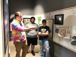 Left to right, Chris Colmer, Hughston Burnheimer and Sydney May stand inside the museum at the President James K. Polk Home and Museum.