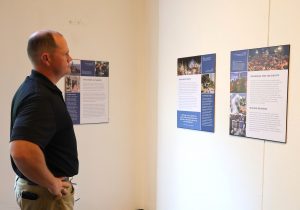 The Rev. E.J. Swatsell looks at some of the posters in the exhibit.