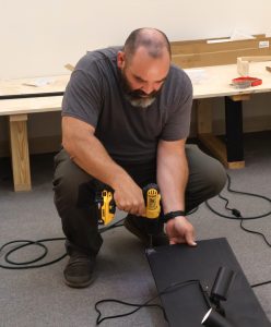 Dr. Peter Noll works on a lighting track.