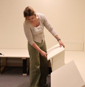Sydney May installs a reading rail.