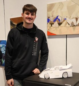 Kyler Hayes shows the race car he created.