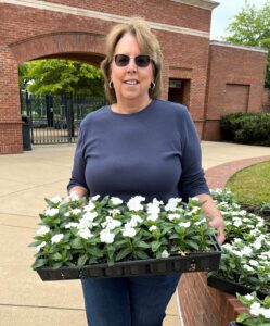Susan Price holds some of the flowers that were planted.