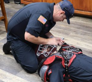 A member of the Bristol Fire Department practices the removal of a helmet.