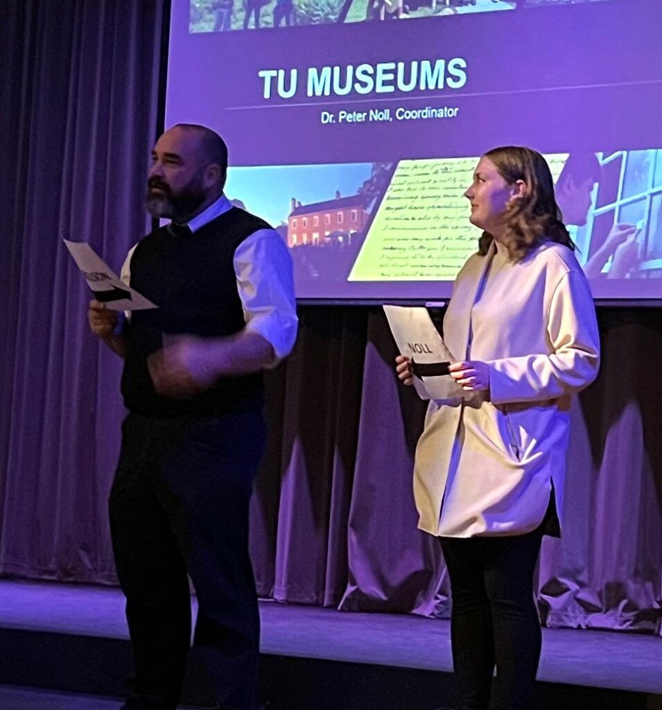 Dr. Peter Noll, left, and Samantha Nelson speak.