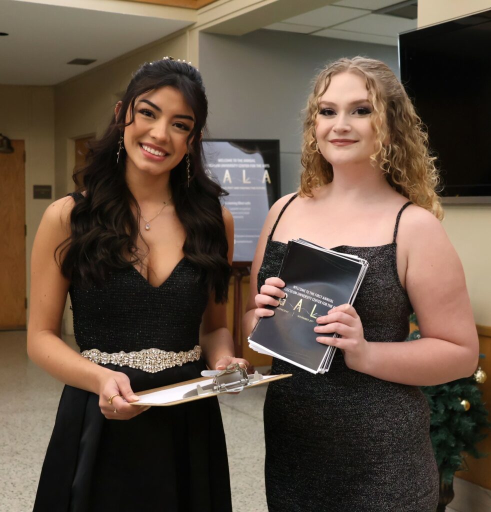 Student hostesses Maria Torres, left, and Savannah Webb