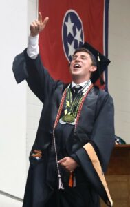 Master’s degree recipient Zackary Nelson celebrates after his name is called during graduation.