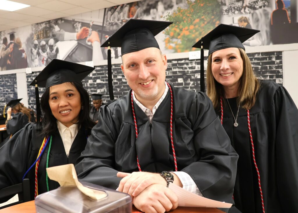 It's picture time for these three graduates on 12-9-23.