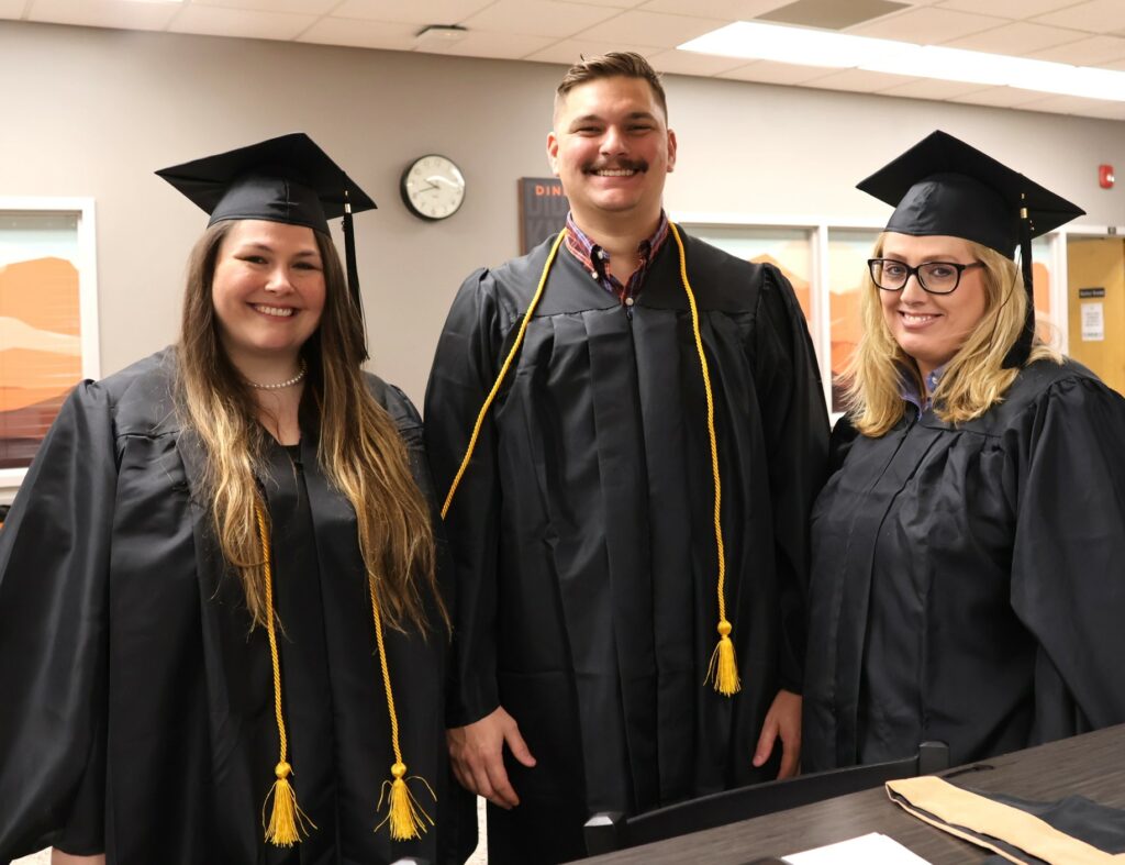 Three more graduates pose for a photo before the 12-9-23 commencement.