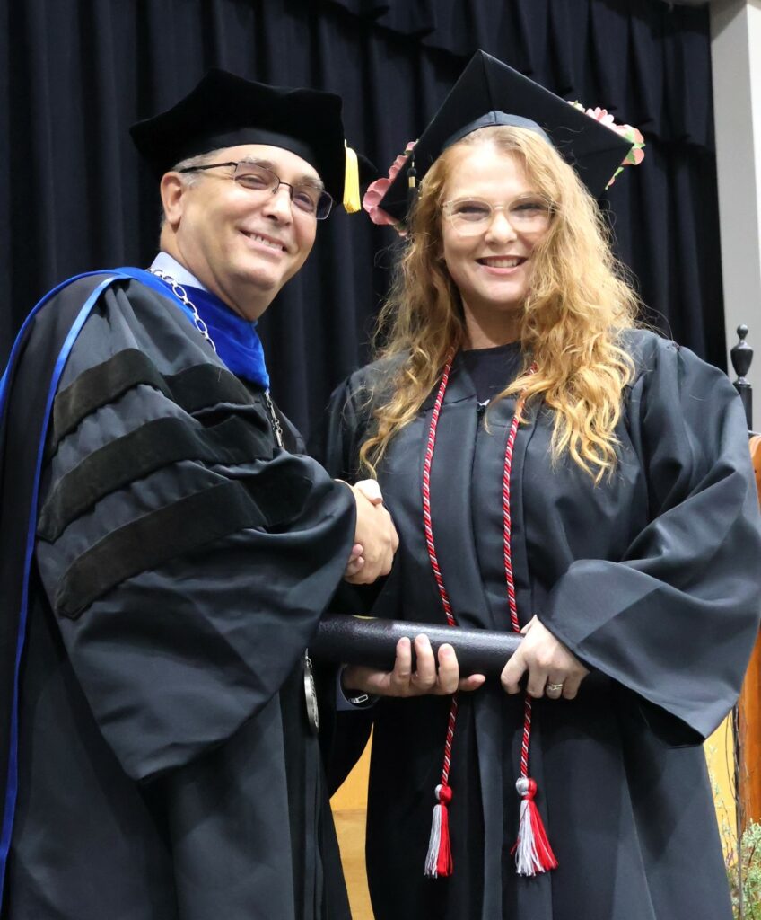 Dr. Scott Hummel, left, congratulates Stacie Bergquist on her graduation.