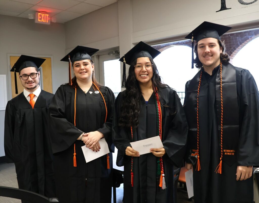 It's picture time for these graduates before commencement 12-9-23.