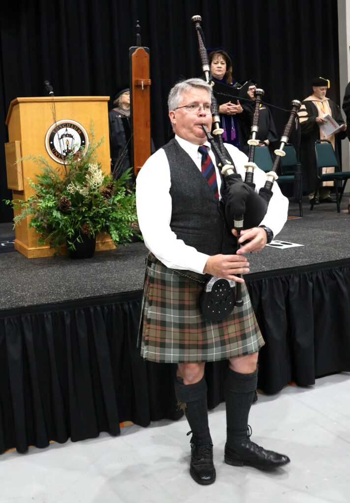 The piper at the commencement ceremony 12-9-23