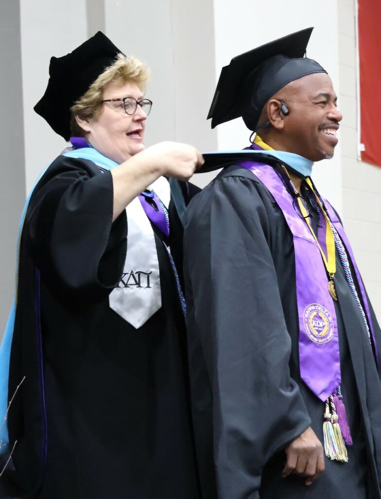 Dr. Peggy Goodson-Rochelle hoods a Master of Arts in Teaching graduate on 12-9-23.