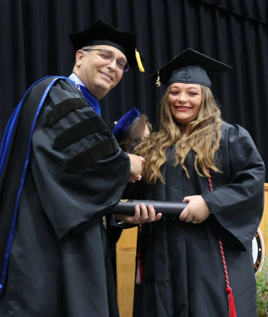 Dr. Scott Hummel, left, congratulates a graduate on 12-9-23.