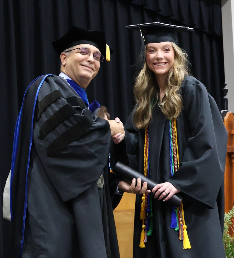 Dr. Scott Hummel, left, congratulates graduate Gwen Gustafson on 12-9-23.