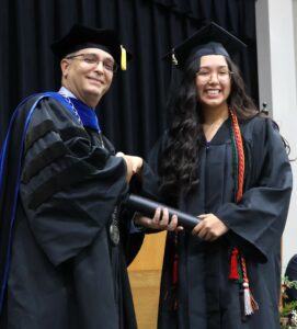 Dr. Scott Hummel, left, congratulates Mirna Jacinto Ramirez, who graduated with a bachelor’s degree in environmental science.