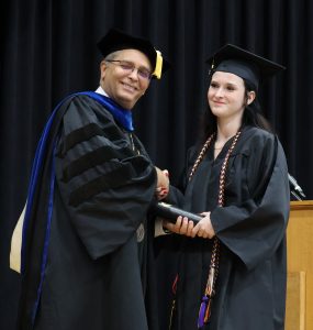 Lily Burgner, right, receives congratulations from Dr. Scott Hummel, Tusculum’s president.