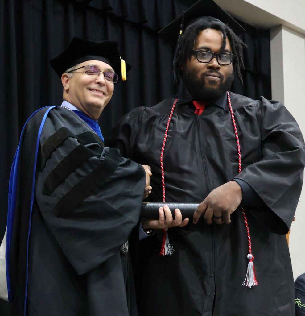 Dr. Scott Hummel, left, congratulates graduate Mark Steward on 12-9-23.