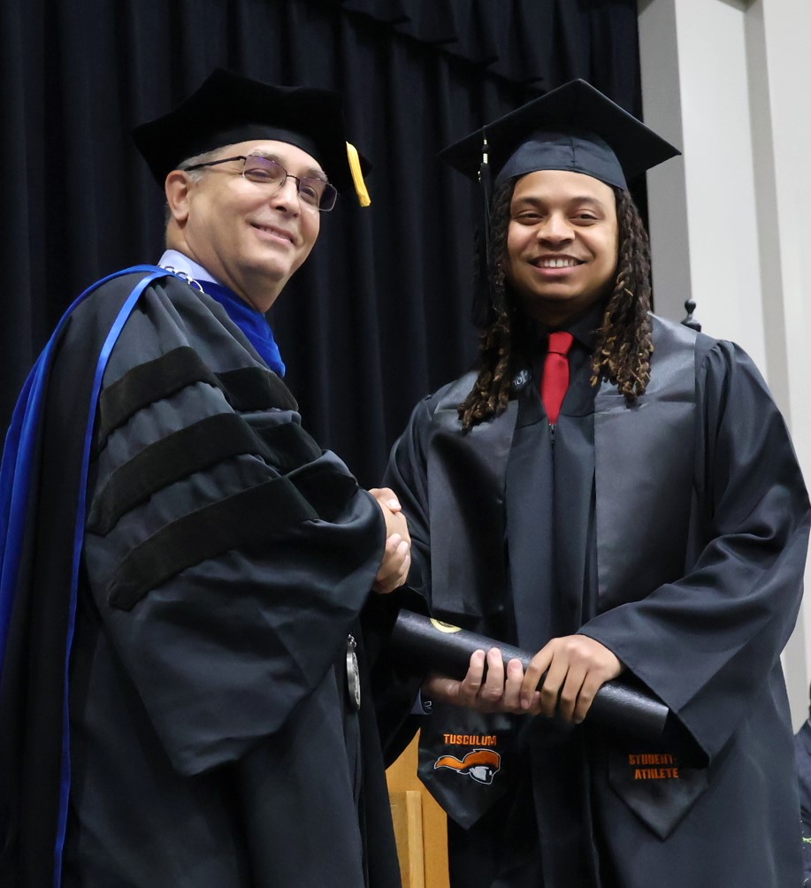 Dr. Scott Hummel, left, congratulates a graduate on 12-9-23.