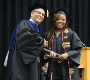 Emerald Jones, right, celebrates her graduation with Dr. Scott Hummel.
