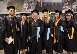 These graduate students join together for a photo before the graduation ceremony.