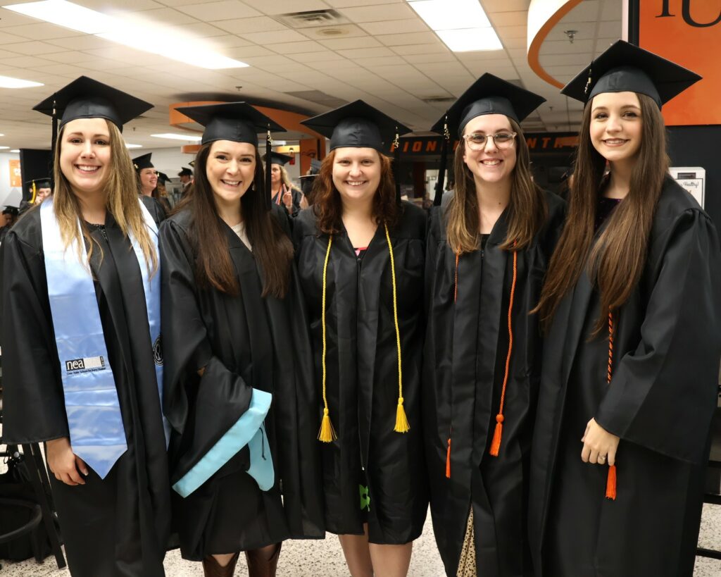 Five graduates pose for a photo before the 12-9-23 commencement.