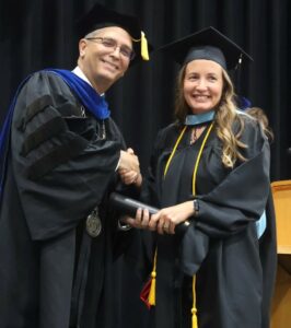 Cynthia Brown, right, celebrates her graduation with Dr. Scott Hummel.