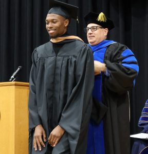 Dorian Craven is hooded by Dr. Chris Kauffman.