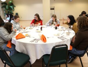 Students enjoy the soup during the meal.