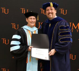 Dr. Suzanne Byrd, left, celebrates her receipt of the Outstanding Faculty for Excellence in Teaching, Service and Scholarship Award with Dr. David Cook.